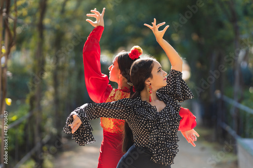 Pair of female flamenco dancers performing a choreography outdoors