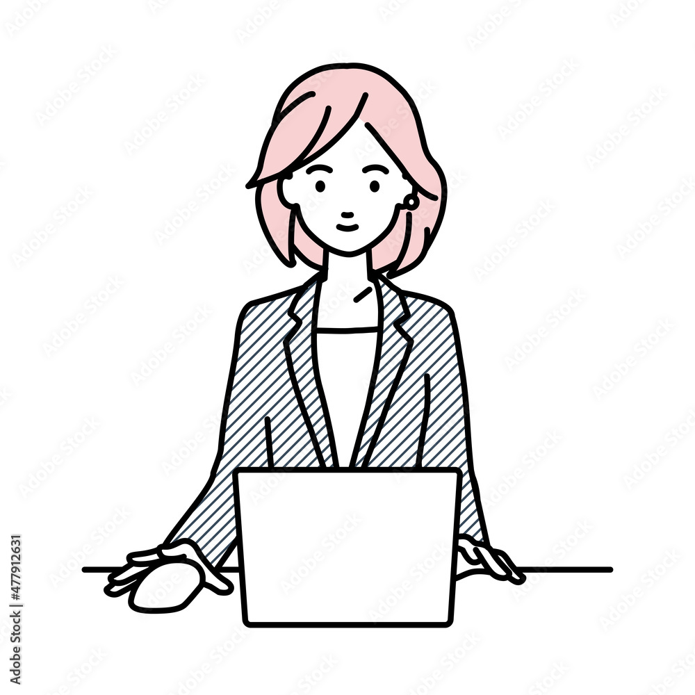 デスクで座ってPCを使っているスーツの女性