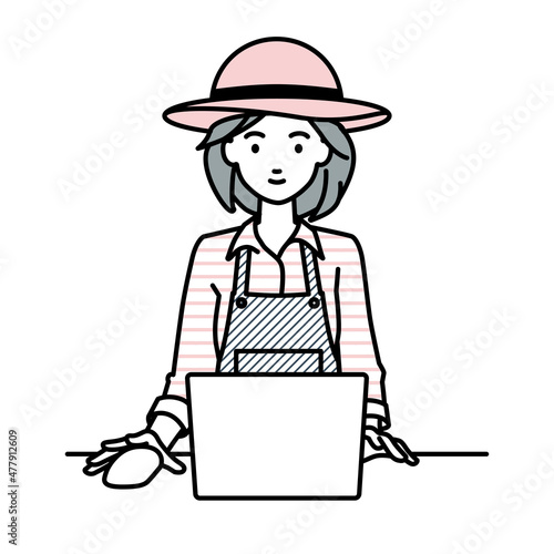 デスクで座ってPCを使っている農家の女性