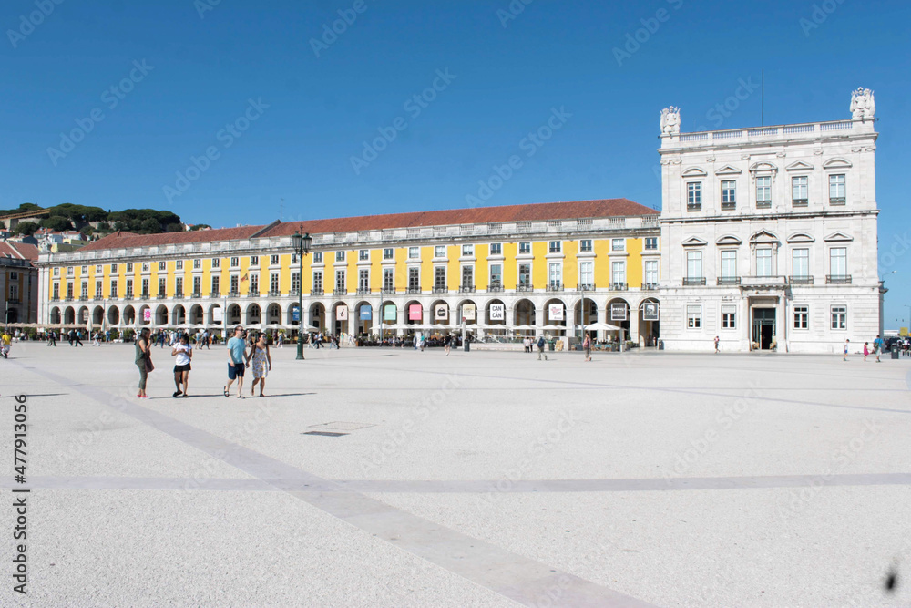 Yellow facades  with many Roman arches in the old buildings of Praça do Comércio in Lisbon, Portugal. It is one of the largest squares in Europe.