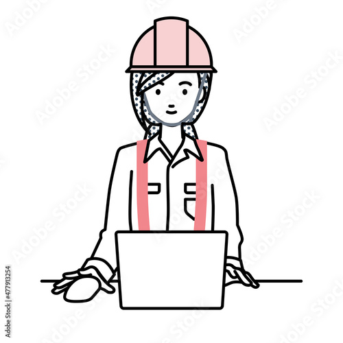デスクで座ってPCを使っている工事現場の女性