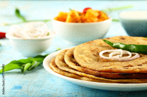 Fresh homemade  aoo paratha served with raita and potato curry- Punjabi dhaba style cooking. photo