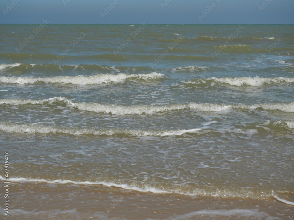 Ocean wave with white bubbles, Green sea water and Nautical landscape background. Seaside horizon view, Waves and  the beach 