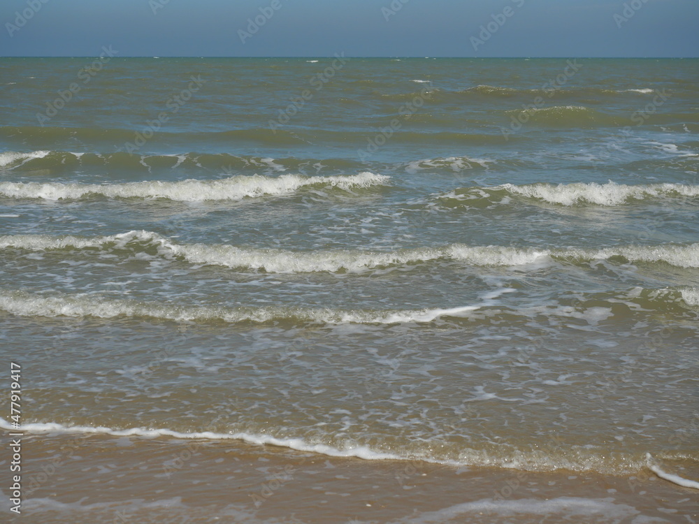 Ocean wave with white bubbles, Green sea water and Nautical landscape background. Seaside horizon view, Waves and the beach Ocean wave with white bubbles, Green sea water and Nautical landscape background. Seaside horizon view, Waves and the beach