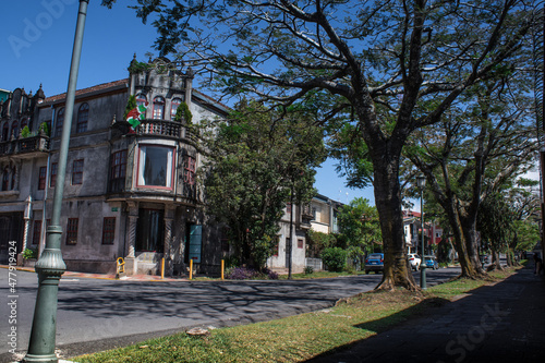 horizontal shot facade of classic building and a street with trees on a sunny day in San Jose in Costa Rica