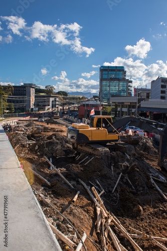 vertical shot of tractor working on urban road construction in the city