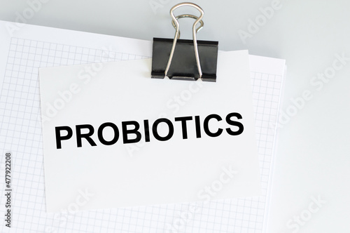 PROBIOTICS - word written on card on clip attached to the blonde on the table