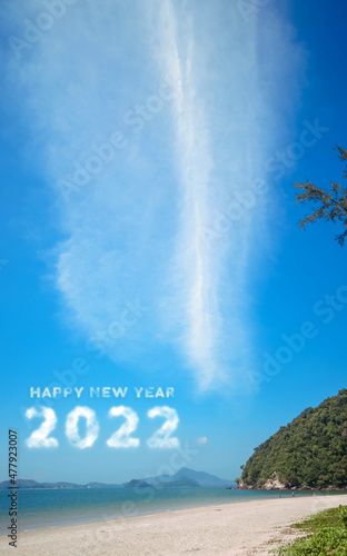 2022 in the sky. Concept Start new year 2022 written with numbers rising from the cloud the coast of the sea, beach