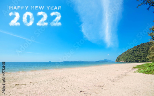 2022 in the sky. Concept Start new year 2022 written with numbers rising from the cloud the coast of the sea, beach