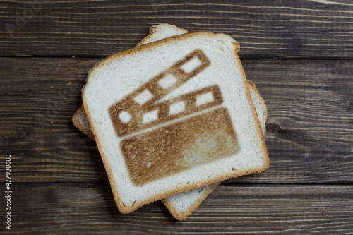 toast with a movie sign on dark wood.