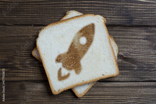 toast with rocket sign on dark wood.