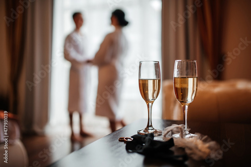 wedding, two glasses of champagne, and on the background of the bride and groom © Павел Чигирь