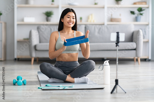 Remote Coaching Concept. Smiling Asian Fitness Trainer Recording Video Tutorials At Home Free Download Remote Coaching Concept. Smiling Asian Fitness Trainer Recording Video Tutorials At Home - GFXLoad