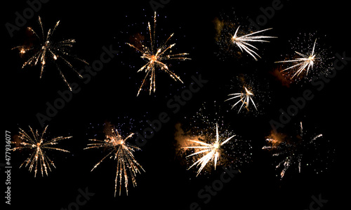 Textures of festive fireworks and bright particles on a black background