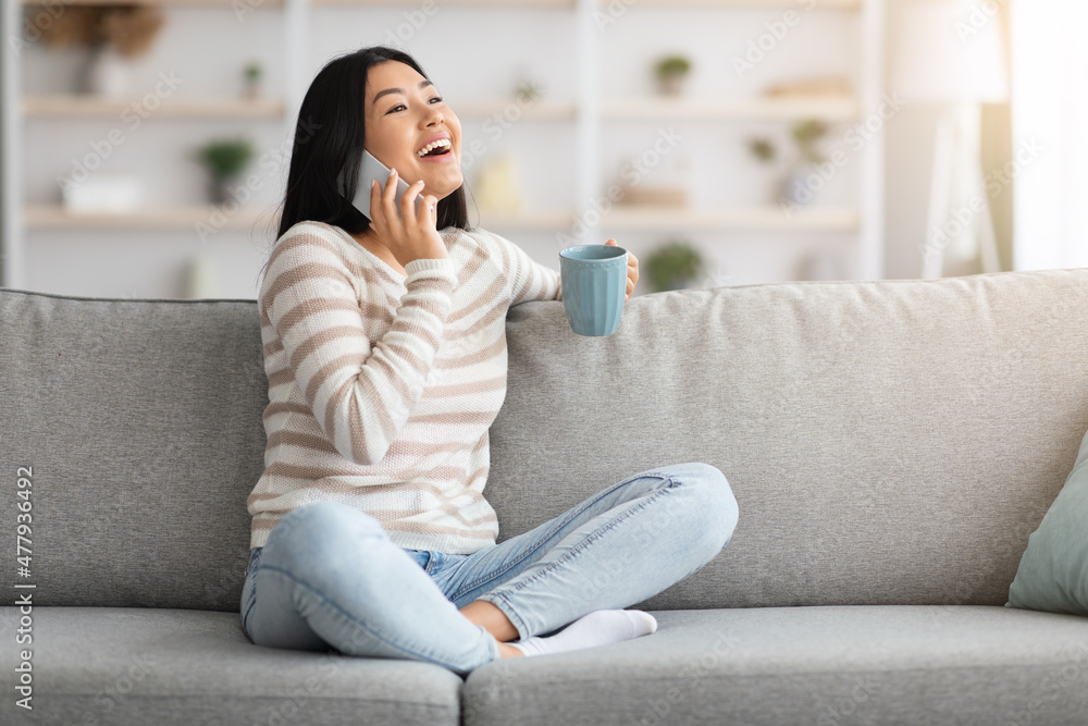 Cheerful Asian Woman Talking On Mobile Phone And Drinking Coffee At Home, Cheerful Asian Woman Talking On Mobile Phone And Drinking Coffee At Home,