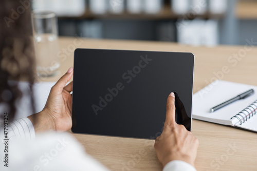 Business woman working with computer tablet and using gadget for searching information online at office desk