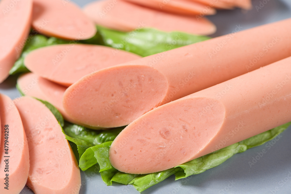 slice of sausages in plate close up. slice of sausages in plate close up.