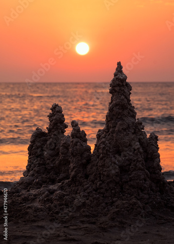 Sand castle on the sea at sunset