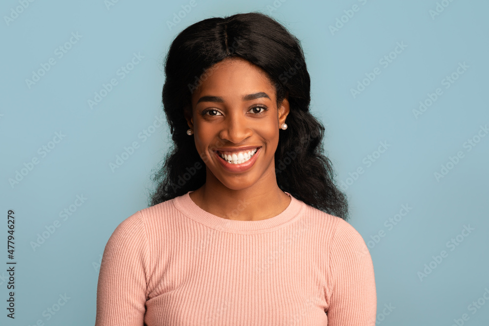 Closeup Portrait Of Happy Smiling Beautiful African American Woman Over Blue Background Closeup Portrait Of Happy Smiling Beautiful African American Woman Over Blue Background
