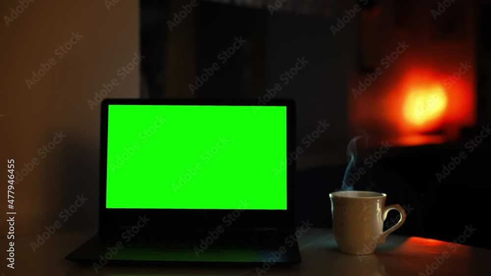 An ascetic corner for working at the computer at home with a cup of hot tea An ascetic corner for working at the computer at home with a cup of hot tea