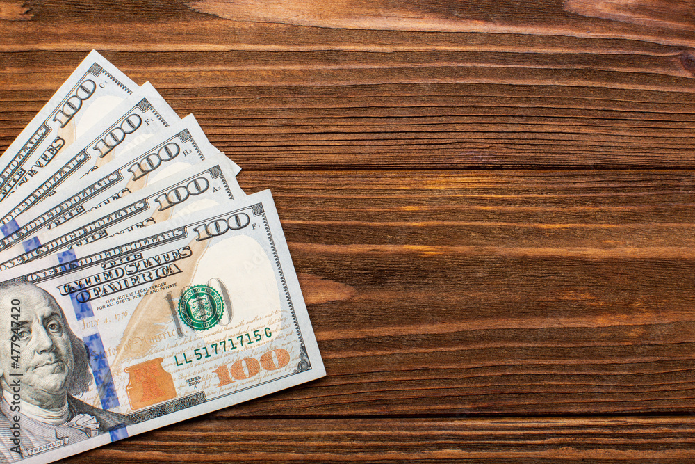 Hundred dollar bills background, top view with empty space for text Hundred dollar bills background, top view with empty space for text