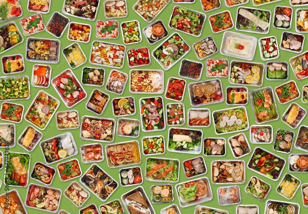 Collection of foil takeaway containers with healthy food over green background Collection of foil takeaway containers with healthy food over green background