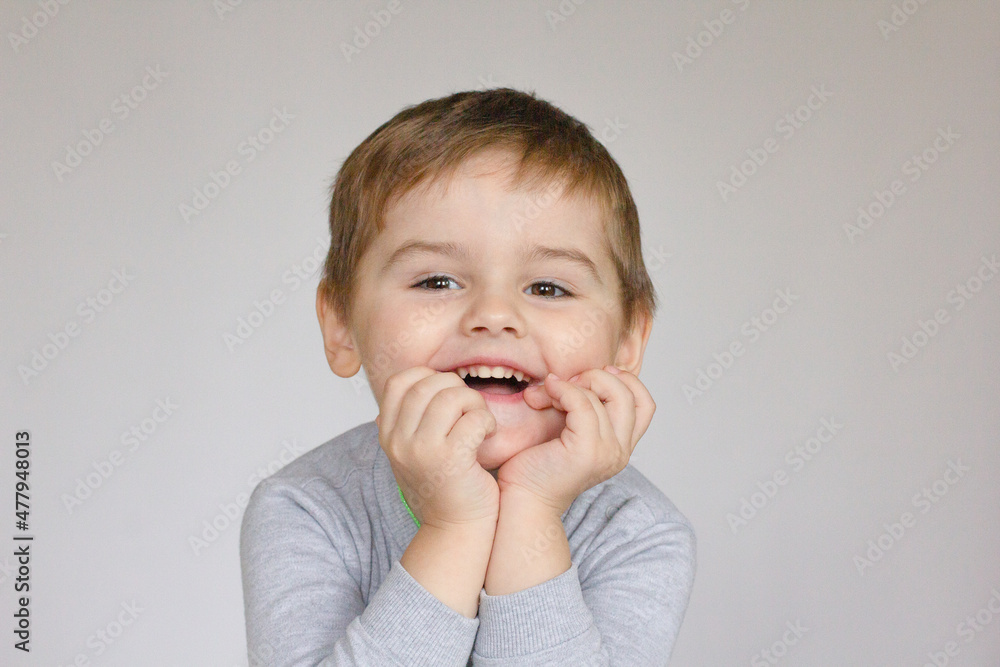 Handsome little boy in cardigan and shirt isolated on grey background Handsome little boy in cardigan and shirt isolated on grey background