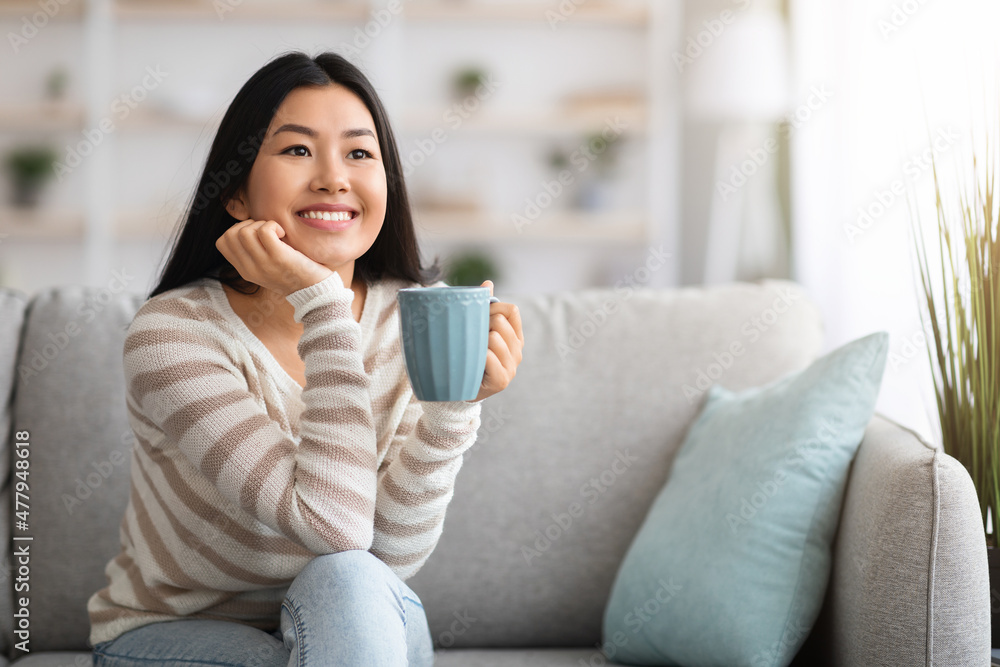 Weekend At Home. Happy Korean Lady Relaxing On Couch With Coffee Weekend At Home. Happy Korean Lady Relaxing On Couch With Coffee