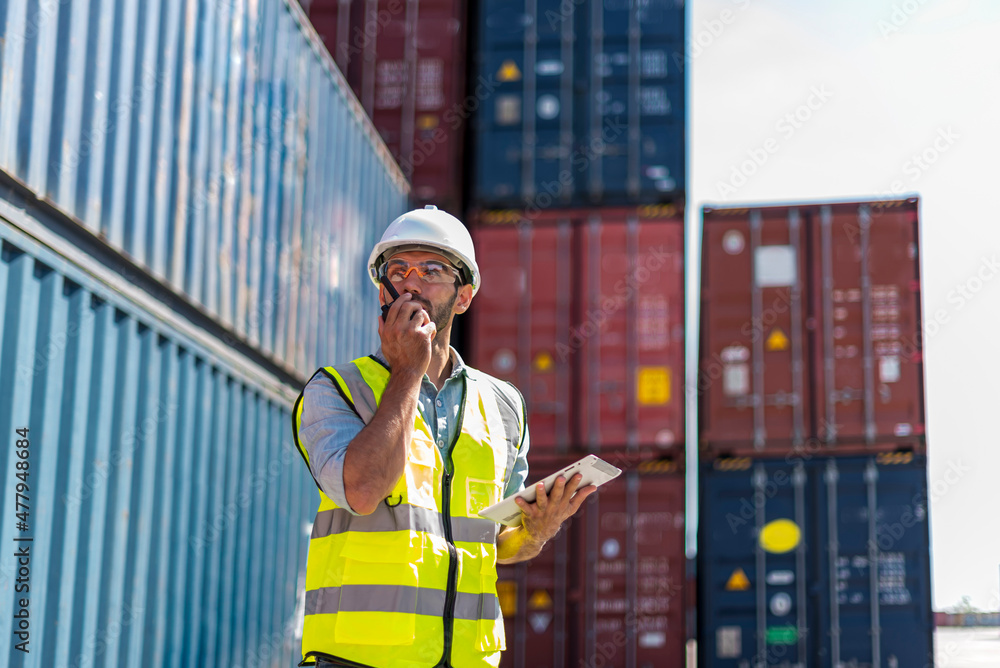Logistics engineer stand on and Pointing up around Shipping container stacker in commercial transport port