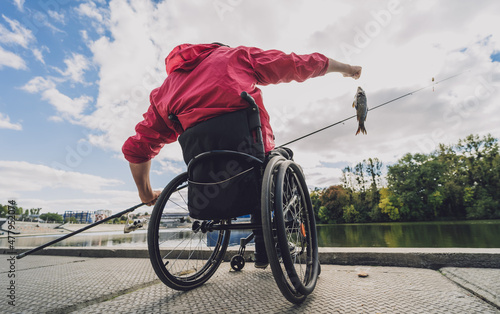 Canvas Person with a physical disability who uses wheelchair fishing from fishing pier