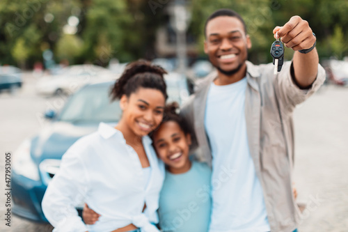 Joyful African American Family Showing New Car Key Standing Outdoors