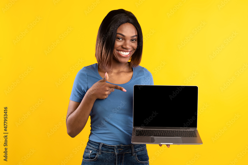African American Woman Showing Laptop Empty Screen Over Yellow Background African American Woman Showing Laptop Empty Screen Over Yellow Background