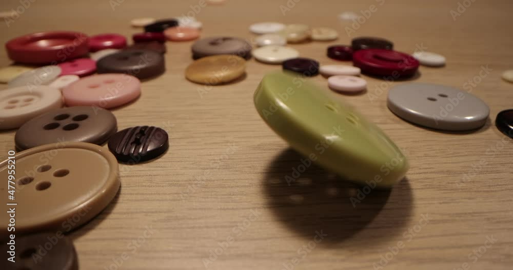 Button for sewing. Button spin on the table. Concept of extreme macro of tailoring and sewing. Button for sewing. Button spin on the table. Concept of extreme macro of tailoring and sewing.