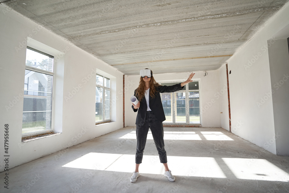 Woman in VR headset in the middle of empty room Woman in VR headset in the middle of empty room