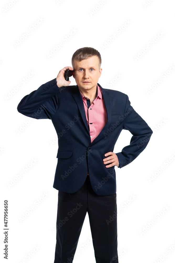 a young man in a suit speaks on the phone. portrait. isolated a young man in a suit speaks on the phone. portrait. isolated