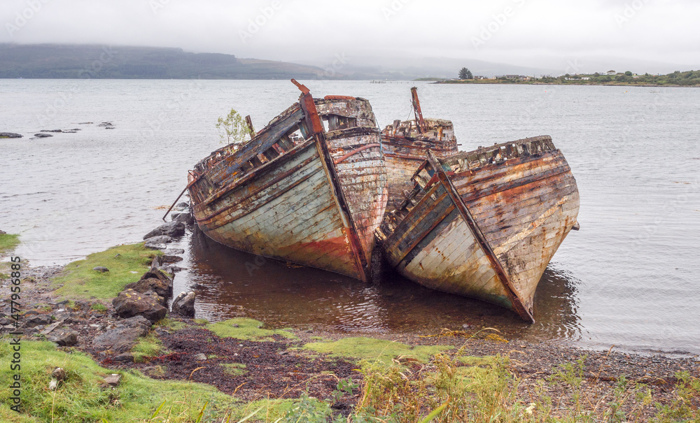 Old wrecked fishing boats at Salen beach, Isle of Mull, Scotland, uk Old wrecked fishing boats at Salen beach, Isle of Mull, Scotland, uk