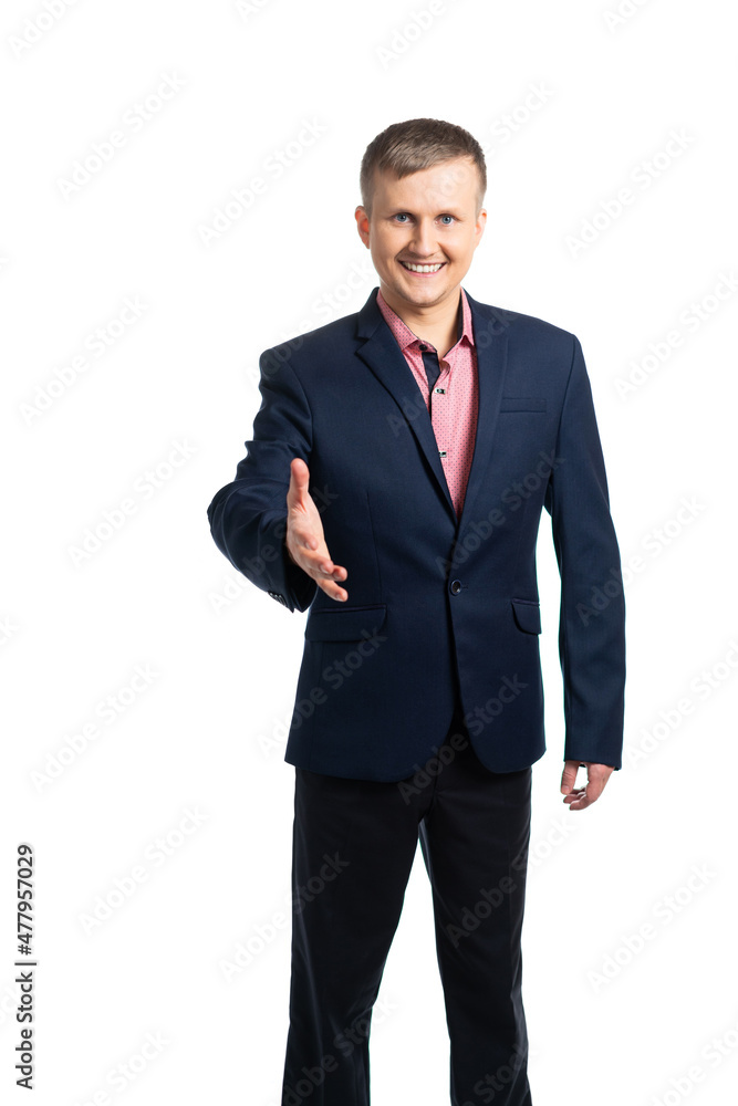 a young man in a business suit smiles and holds out his hand for a welcome handshake. isolated a young man in a business suit smiles and holds out his hand for a welcome handshake. isolated