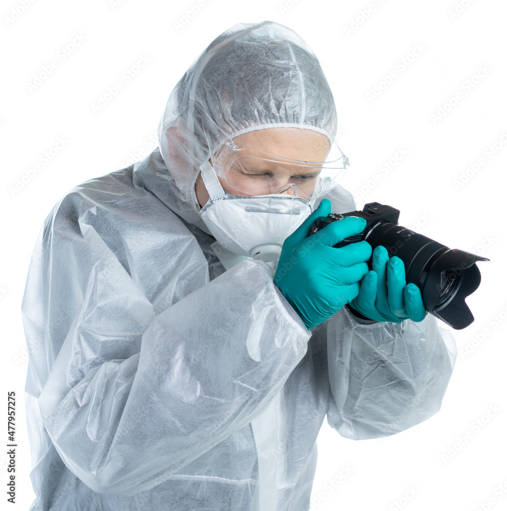 Lab technician in protective uniform with a camera. reporter, journalist captures events on the camera. close-up. isolated Lab technician in protective uniform with a camera. reporter, journalist captures events on the camera. close-up. isolated