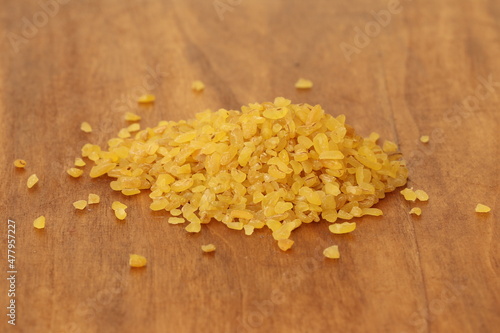 Wheat on a wood background. Wheat porridge burgun.  photo