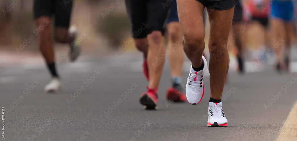 Marathon running race, people feet on city road, runners run urban marathon in the the city