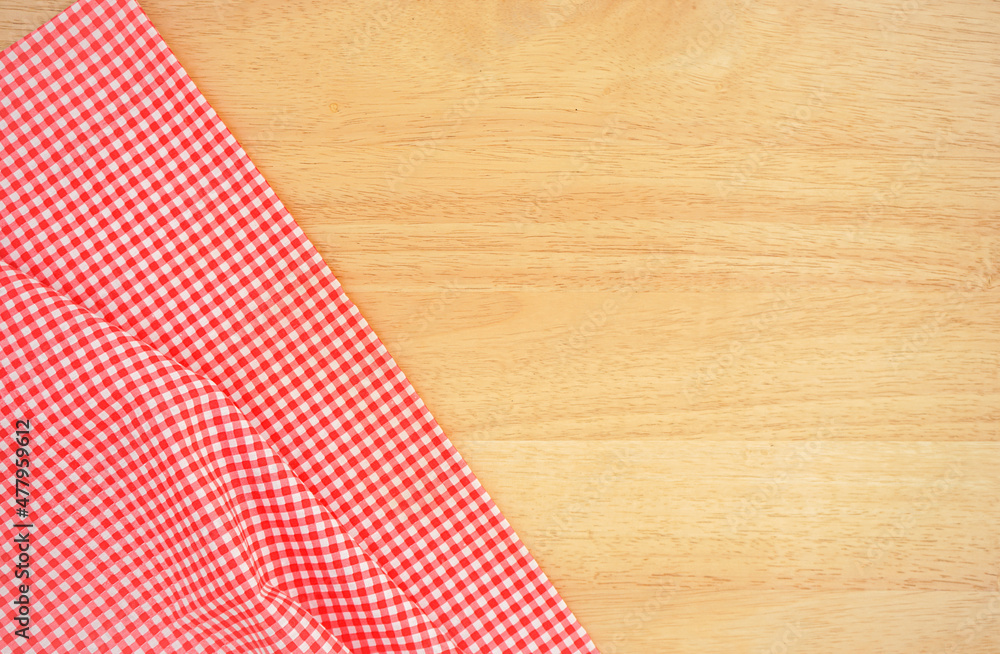 Fototapeta premium Classic pink plaid fabric or tablecloth in the corner of wood desk with copy space