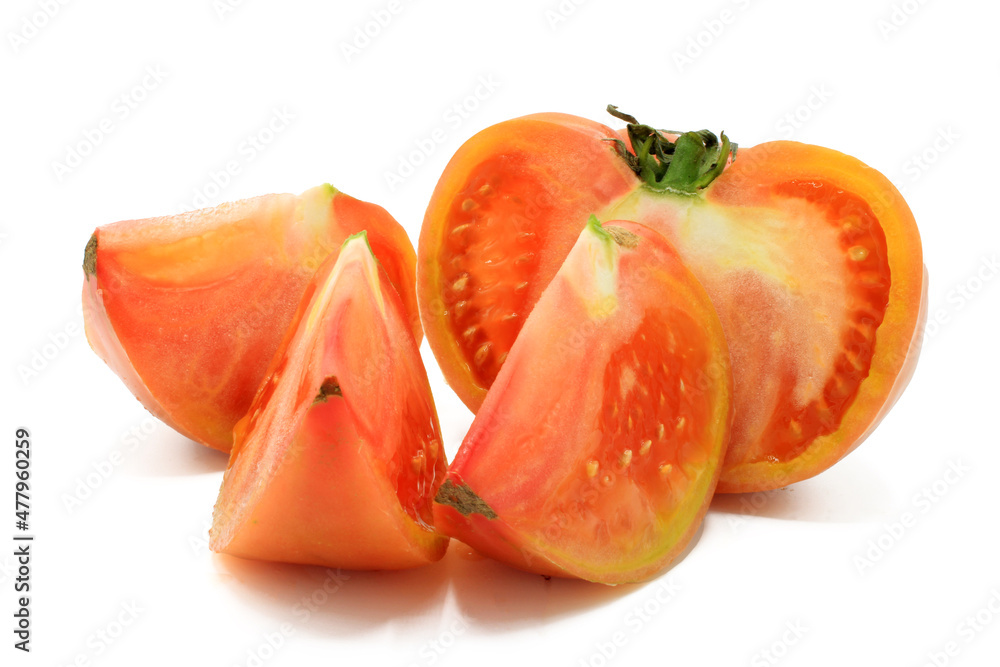 Pink tomato cut into chunks, isolated on a white background Pink tomato cut into chunks, isolated on a white background