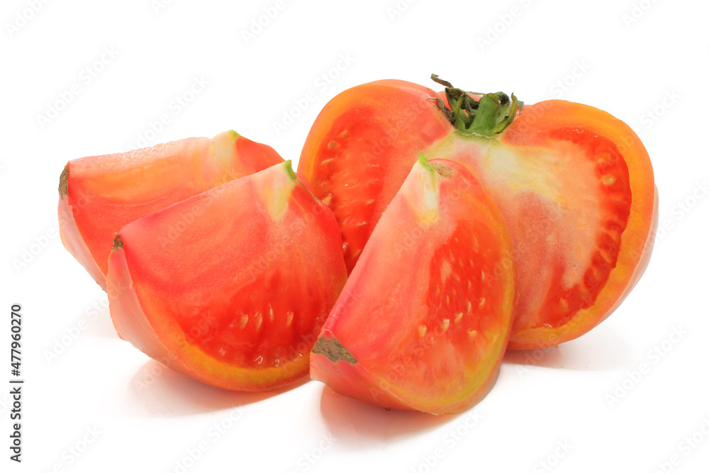 Pink tomato cut into chunks, isolated on a white background Pink tomato cut into chunks, isolated on a white background