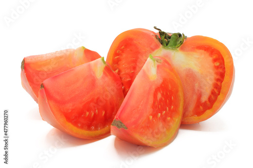 Pink tomato cut into chunks, isolated on a white background
