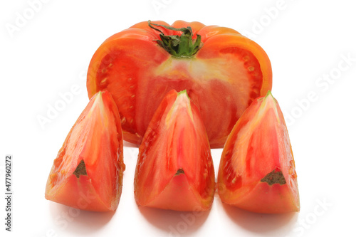 Pink tomato cut into chunks, isolated on a white background