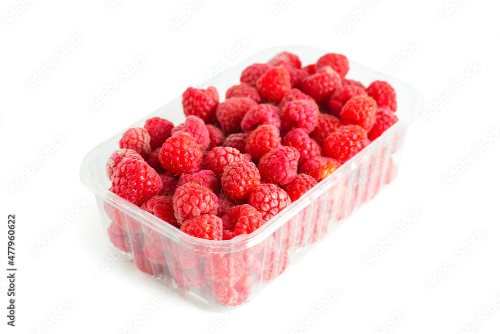 Fresh ripe organic red raspberries in transparent plastic box isolated on white background Fresh ripe organic red raspberries in transparent plastic box isolated on white background