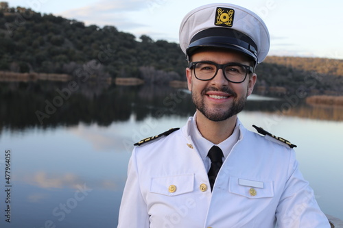 Ship captain with elegant uniform wearing eyeglasses photo