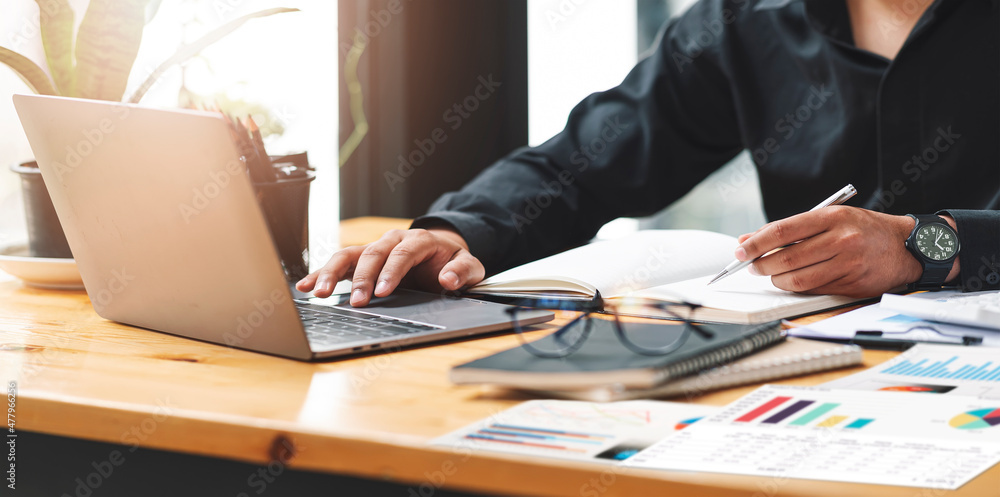 Fototapeta premium businessman working at office with document on his desk, doing planning analyzing the financial report, business plan investment, finance analysis concept.Using calculator and tablet.