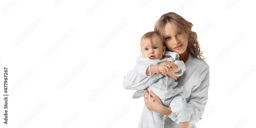 Happy mom holds her baby in her arms and looking at camera. Isolated on white. Format photo 2x1. Happy mom holds her baby in her arms and looking at camera. Isolated on white. Format photo 2x1.