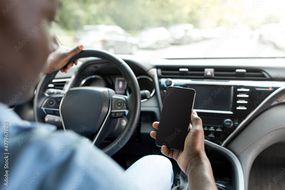 Unrecognizable black man driver holding smartphone, mockup Unrecognizable black man driver holding smartphone, mockup